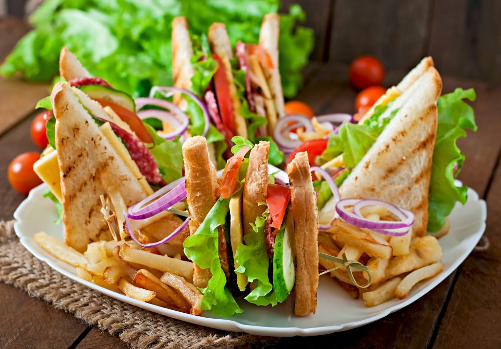 club-sandwich-with-cheese-cucumber-tomato-smoked-meat-salami-served-with-french-fries (1)