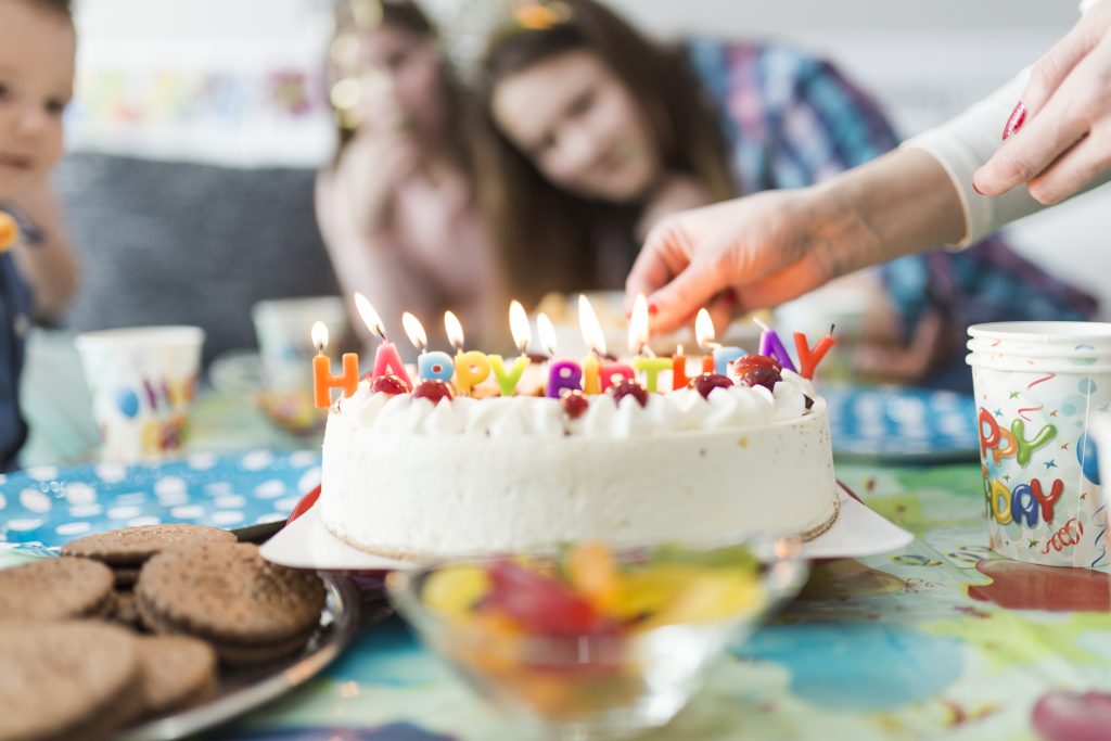 crop-hands-near-cake-with-candles